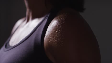 Close-Up-Of-Beads-Of-Sweat-On-Shoulder-Of-Mature-Woman-Wearing-Gym-Fitness-Clothing-Exercising